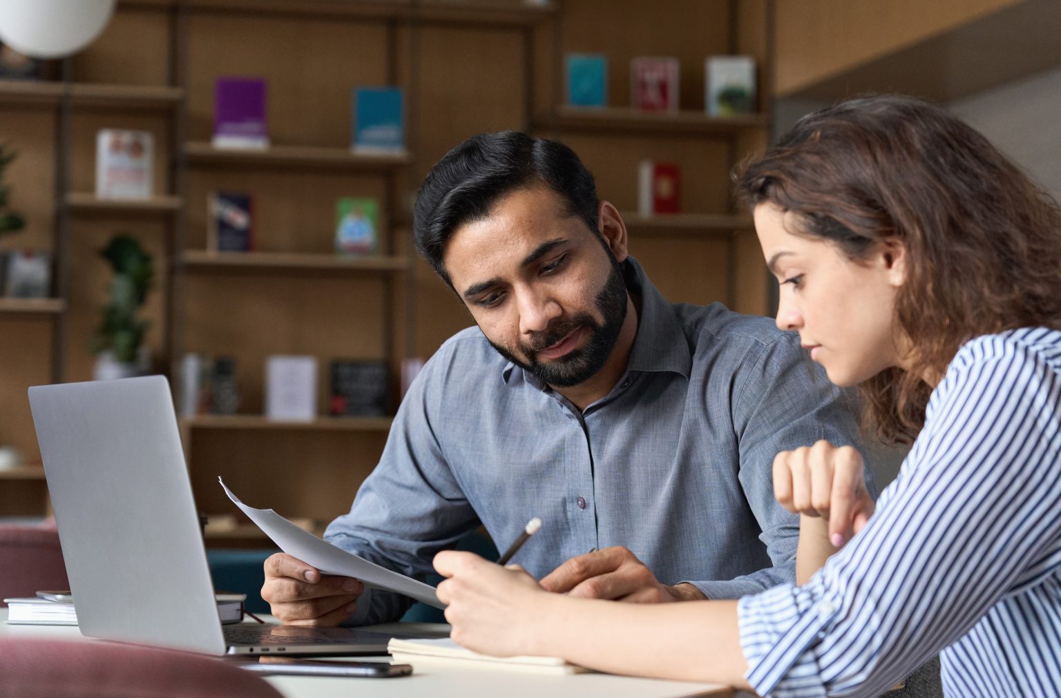 Man helping woman with paperwork