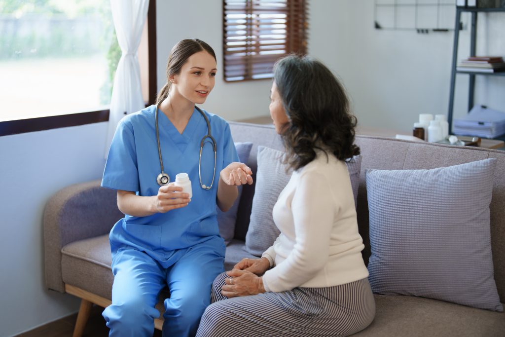 Nurse giving medication to an older woman
