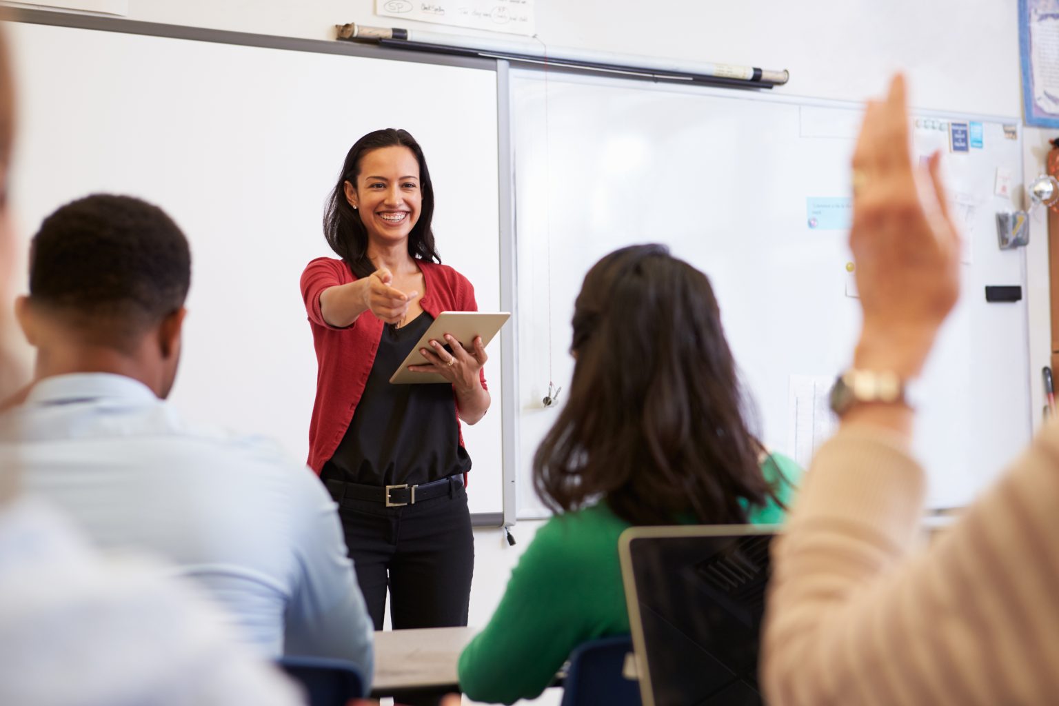 Woman pointing to a member of her class